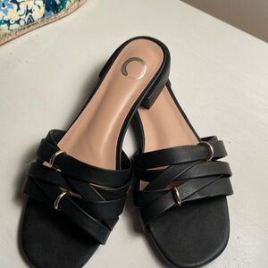 Black sandals with gold accents